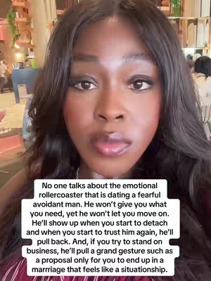 A woman with dark hair and makeup is centered in the frame, looking directly at the camera with a serious expression. A white rectangular text overlay is at the bottom, with the woman’s image filling the background. The natural light and blurred background suggest an indoor restaurant or cafe setting.