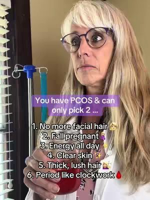 A woman with blonde hair and glasses looks quizzically at the camera, holding what appears to be a beaker or vial filled with a dark red liquid. Overlay text lists six possible symptoms of PCOS, asking the viewer to 'pick 2'. The background suggests an indoor setting near a window.
