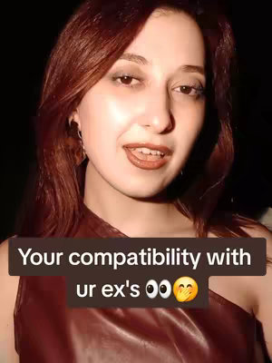 A woman with long auburn hair is centered in the frame, her light skin contrasting with a dark background. She is looking directly at the camera with a slightly open mouth, as if mid-sentence, and a subtle smile. A text overlay appears in a rectangular black shape covering her lower chest area, reading 'Your compatibility with ur ex's 👀🫶'.