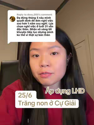 A young woman with long dark hair is centered in the frame, looking directly at the camera. Behind her is a simple blurred background. A comment from a user is displayed in a speech bubble in the top left corner of the image, and some overlaid text appears toward the bottom of the frame.