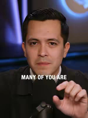 A man with dark hair and a black jacket is centered in the frame, facing the camera. The image has a professional studio-style setting. Above the man's head, text overlayed on the image reads, 'MANY OF YOU ARE'. The background is subtly blurred with shades of blue and purple.