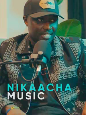 A medium shot of a man in a black cap and patterned jacket, speaking into a microphone. The text overlay includes "NIKAACHA MUSIC". The lighting seems professional, with a muted, greenish background. The overall layout is focused on the individual with a clear message.