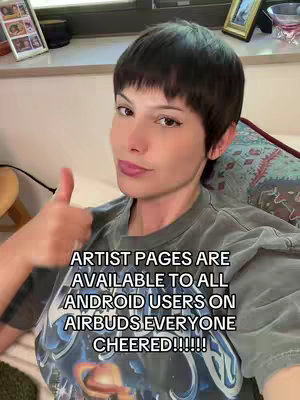 A woman with short dark hair is shown from the chest up, giving a thumbs-up. The overlay text, in white, announces the availability of artist pages on Airbuds.