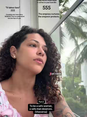 A woman with curly dark hair looks off to the side while seated near a window. Text overlays provide context. In the corner, there is a logo that says "A Safe Feminine". The main subject is the woman, slightly angled with a natural expression.