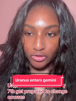 A close-up shot features a Black woman with long, dark hair that cascades down her shoulders. Her skin is smooth, with a light, pink background. She slightly sticks out her tongue. On her face there is a text overlay in a rectangular black box with white and pink fonts.