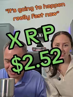 Two people are looking towards the camera with text overlayed. A man is on the left with gray hair is wearing a blue shirt and the woman on the right has long brown hair and is wearing a beige sweater. A digital sign that has a green outline says 'XRP $2.52' and above this there is a text that says 'It's going to happen really fast now'.