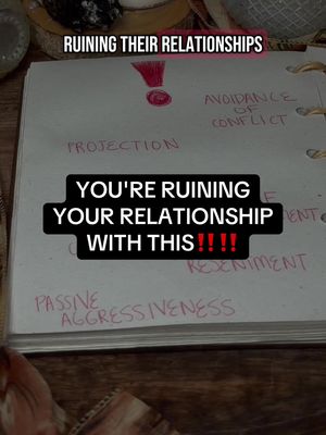 An overhead shot of an open journal or notebook on a wooden surface, with handwritten text in red and black ink. The words 'RUINING THEIR RELATIONSHIPS' are at the top, framed by dark text overlaid with a rectangular black box. The text 'YOU'RE RUINING YOUR RELATIONSHIP WITH THIS!!!!' in bold, white letters inside the box, followed by other handwritten words like 'PROJECTION', 'AVOIDANCE OF CONFLICT', and 'PASSIVE AGGRESSIVENESS'. A large exclamation mark is drawn in red ink near top.