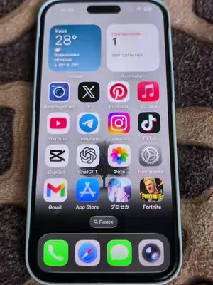 The cover image displays the home screen of an iPhone. The screen is filled with various app icons, including YouTube, Telegram, Instagram, TikTok, CapCut, ChatGPT, Gmail, App Store, and Fortnite. The top of the screen shows weather and calendar widgets. The phone has a light blue case and is placed on a patterned surface.