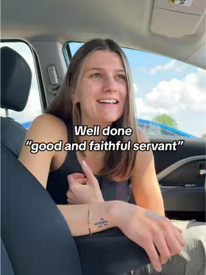 A woman is seated in a car, angled towards the camera, appearing to be in mid-sentence with a smile. Text overlayed on the image reads, "Well done 'good and faithful servant'." The background is blurred with a blue vehicle visible.