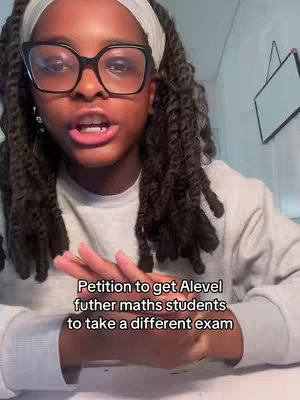 A young Black woman with large glasses is talking to the camera. She has her hair in long braids and is wearing a white headband and a grey sweater. Black text on the bottom of the image conveys her caption topic.