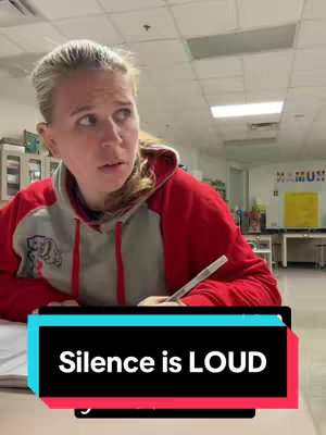 The cover image shows a woman looking up with a pen in her hand, seemingly pondering. She's wearing a red and gray hoodie, and there's text overlaid at the bottom. The background appears to be a classroom setting.