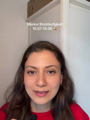 A woman with long, dark hair and a red top looks directly at the camera. The background is a plain white door and wall. Text overlay says 'Merkur Rückläufigkeit 10.07-10.08'.