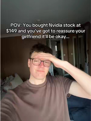 A selfie-style video cover image showing a young man in a brown shirt and glasses, looking thoughtful with his hand on his forehead. The background has a neutral color palette, and text overlayed on image which reads: "POV: You bought Nvidia stock at $149 and you've got to reassure your girlfriend it'll be okay..."