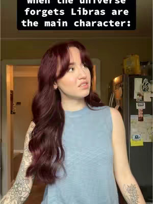 A woman with long auburn hair is looking slightly to the side with a thoughtful expression. She's wearing a light blue sleeveless top. The background includes a domestic setting with a doorway and a view into another area. Overlaying the image is a black banner with white text.