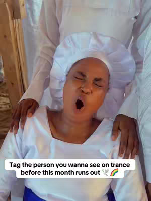 A woman in white robes and a head covering is featured in the center, her mouth wide open as if in a trance. Two people in white robes are behind her, their hands gently resting on her shoulders. A text overlay at the bottom reads, 'Tag the person you wanna see on trance before this month runs out' with a dove and a rainbow emoji.