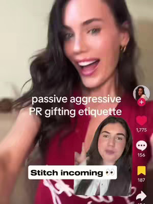 The cover image is a vertical video still featuring a woman with dark hair, looking directly at the camera with an open mouth as if she’s speaking. Overlaying the image is text in white font describing the video’s topic, "passive aggressive PR gifting etiquette". Below it, a smaller inset video shows another woman, pointing and talking, indicating a "Stitch" style video. The background is neutrally lit, suggesting a casual setting, and there are floating social media icons such as a heart, speech bubble, and a bookmark type of icon.