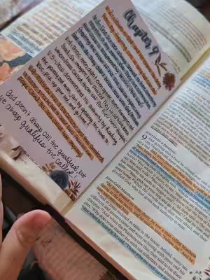 The cover image features an open Bible with handwritten notes and colorful highlights on the pages. The Bible is decorated with floral elements. The image is shot in a close-up, capturing the details of the notes and annotations.