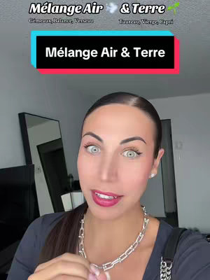 A woman with her hair pulled back and a silver necklace looks directly at the camera. Behind her, a sign reads "Mélange Air & Terre", with the words in turquoise and the background is mostly neutral. The woman's face features, light skin, and pink lipstick are enhanced by soft lighting. In the background, a neutral-toned room with a mirror is partly visible.