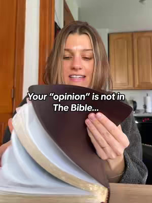 The cover image shows a woman holding a large book, turning its pages. The text overlayed on the image says "Your 'opinion' is not in The Bible...". The background is blurred, showing a kitchen setting.