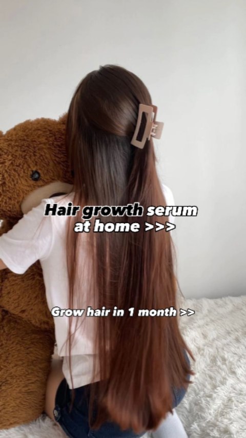 A person is shown from the back, with long brown hair styled in a semi-updo, held by a clip. They are holding a teddy bear, and the background is a simple, blurred interior setting. Text overlays are placed on the image for emphasis.