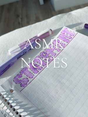 The cover image shows a close-up of a notebook with a handwritten banner. Two purple pens are placed diagonally across the image in the upper left. The banner is in the center, hand-lettered with the words "ASMR NOTES" in large, bubble-style letters. The background appears to be a white surface, possibly a bed or a desk.