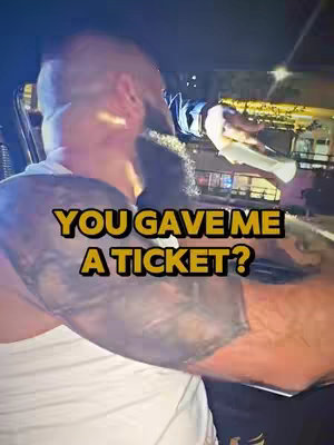 The image shows a man from the back, leaning into a car, with the text overlay 'YOU GAVE ME A TICKET?' across the bottom in yellow.