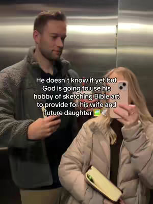 A couple stand close together in a well-lit space, with a man on the left and a woman on the right. The man, with short brown hair and a gray jacket, looks down slightly. The woman holds her phone up to take a picture, with her face partly obscured and a book in her other hand. Overlay text on the image describes that God will use the man's hobby of sketching Bible art to provide for his family.