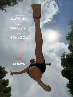 Image from a low angle captures a person suspended mid-air with their legs extended upwards, set against a bright blue sky with puffy white clouds and the sun shining. The person, wearing athletic attire, seems to be celebrating or showcasing their running efforts. Overlayed text shows running metrics and the Strava logo.