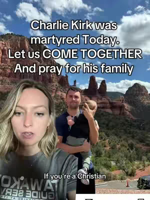 A woman with blonde hair is filming a video with a mountain range as a backdrop. In the background, a man is holding a baby, presumably the woman and family are the subjects of this video. Text overlays on the image provide context about a recent event concerning 'Charlie Kirk'.