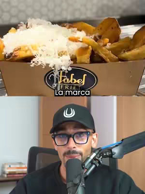 The image is a split view, with the top half showing a close-up of a cardboard container filled with french fries topped with grated cheese. Below, a man with a beard, glasses, a black cap, and a microphone appears to be recording. The background is blurred, suggesting an interior setting.