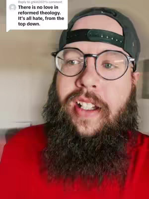 A close-up shot of a man with a full beard, glasses, and a backward baseball cap, speaking with a slight smile. Text in a speech bubble in the top left corner states, 'There is no love in reformed theology. It's all hate, from the top down.' The man is wearing a red shirt.