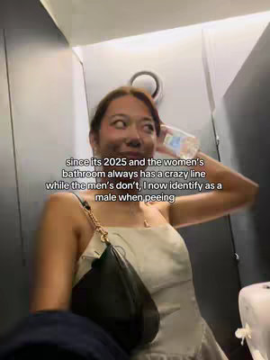 The cover image shows a person in a women's bathroom angled from the bottom. The person is wearing an off-white top and holding a water bottle, seemingly surprised while looking up. Text overlayed on the image poses a statement about bathroom lines.