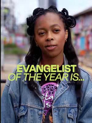 A woman with dark hair styled in braids and wearing a denim jacket faces the camera. Text overlay reads: "EVANGELIST OF THE YEAR IS..."