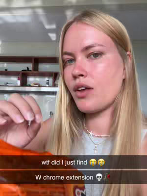 A woman with long blonde hair is holding up a piece of an object, looking towards the camera. Text overlays are placed below the image.