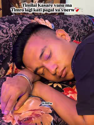 The image features a close-up of a person lying on a floral patterned bed. The person's head is resting on their arm, eyes closed, suggesting sleep or introspection. Text overlays at the top and bottom provide context.