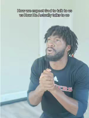 A man with short, dark hair and a beard looks upwards with a pensive expression, hands clasped in front of his chest. Overlayed text at the top contrasts how we expect God to speak to us vs. how He actually speaks to us.