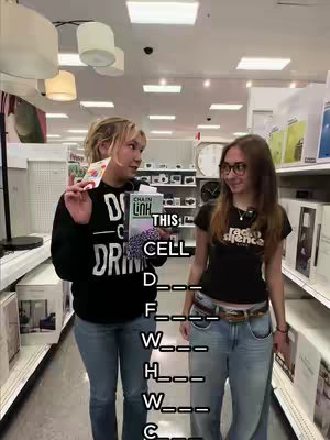 Two young women stand in a store aisle, one holding a small book and a card, the other wearing glasses. The aisle has shelves packed with merchandise. Text overlays are placed on the image to add to the joke.