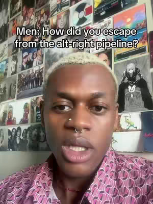 A person with short, bleached hair and a nose ring is centered in the frame, wearing a patterned pink shirt. The background is a wall covered with various images and album covers. The overall composition is a close-up shot, focusing on the person's face and upper body.
