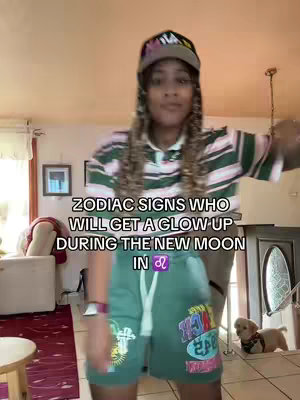 A woman in a striped shirt and cap dances in a domestic setting. Text overlays indicate astrological themes.