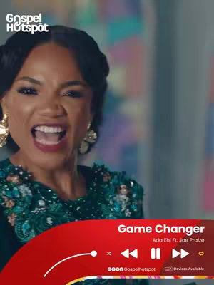 A woman with dark hair and gold earrings is singing with her mouth wide open in front of a colorful blurred backdrop. In the bottom center of the cover, a red media player-like graphic displays text, artist and song title.