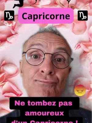 The cover image features a middle-aged man with glasses, centered in the frame. A pink box displaying the word "Capricorne" overlays the top. Around him is a blurred background of pink roses. Below the man is a black rectangle with the text "Ne tombez pas amoureux ...". An angry face emoji is placed on the right side of the frame.