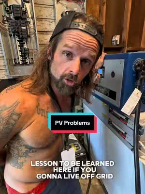 A man with a beard and a backward baseball cap stands in front of electrical equipment, with text overlay on the image. The man is shirtless, and there are tattoos on his chest and arm. The background includes electrical panels and a blue box. The image has a warm, indoor lighting.