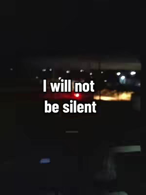 A nighttime shot from inside a vehicle. Streetlights and the tail lights of a car are visible through the windows. The title text 'I will not be silent' is written in white letters over the dark background.
