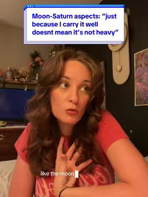 The cover image features a woman with wavy brown hair and a red shirt, looking slightly to the side with a thoughtful expression. Above her is a text box with the quote about Moon-Saturn aspects. The background includes a wall, a clock, and a glimpse of a TV screen.