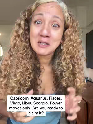 A woman with long, curly light brown hair, facing the camera with a slightly surprised expression and hands up. A white text box at the bottom contains text about zodiac signs.