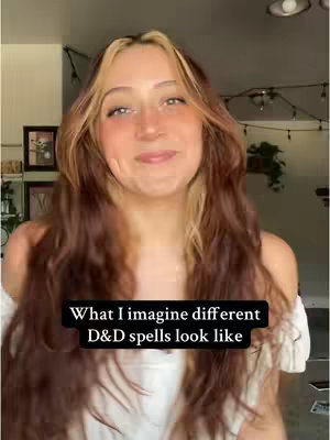 A woman with long, wavy brown and blonde hair smiles at the camera. Text overlayed on the bottom of the image states, "What I imagine different D&D spells look like."
