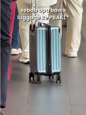 The cover image shows a close-up of a blue suitcase rolling on a polished floor. Text in the upper center reads in Indonesian.