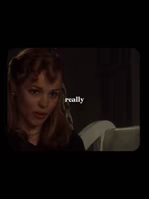 A medium shot of a woman with reddish-brown hair looking towards the left side of the camera with an expression of mild concern. The text 'really' appears in white, centered above her head.
