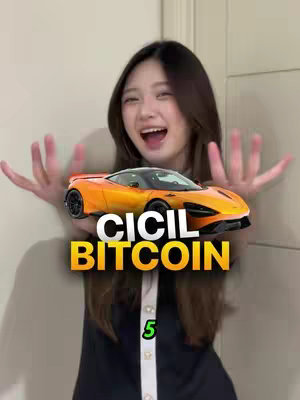 A woman with long brown hair is smiling widely, her arms outstretched with her hands open, as if presenting something. In front of her is an orange McLaren sports car graphic overlaid, with the word "CICIL BITCOIN" in large yellow and black letters below the car. The number "5" is at the bottom in a green box. The background is a simple white wall and a partially visible door.