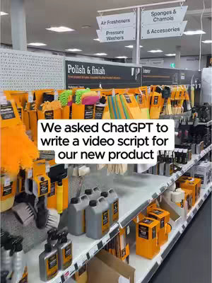 A brightly lit, eye-level shot inside a store. Shelves are packed with cleaning products. Text overlayed at the bottom that states: We asked ChatGPT to write a video script for our new product.